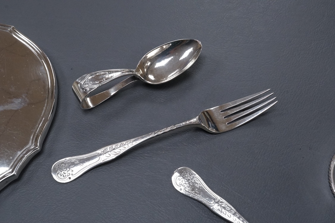 A George V silver mounted hand mirror, a silver spoons and pusher, a silver christening fork and spoon and a silver plated tea caddy.